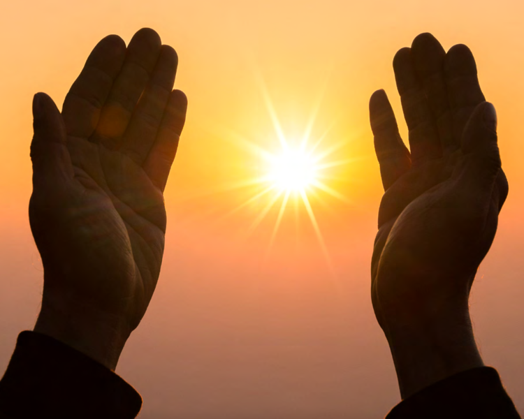 Two hands facing the sun